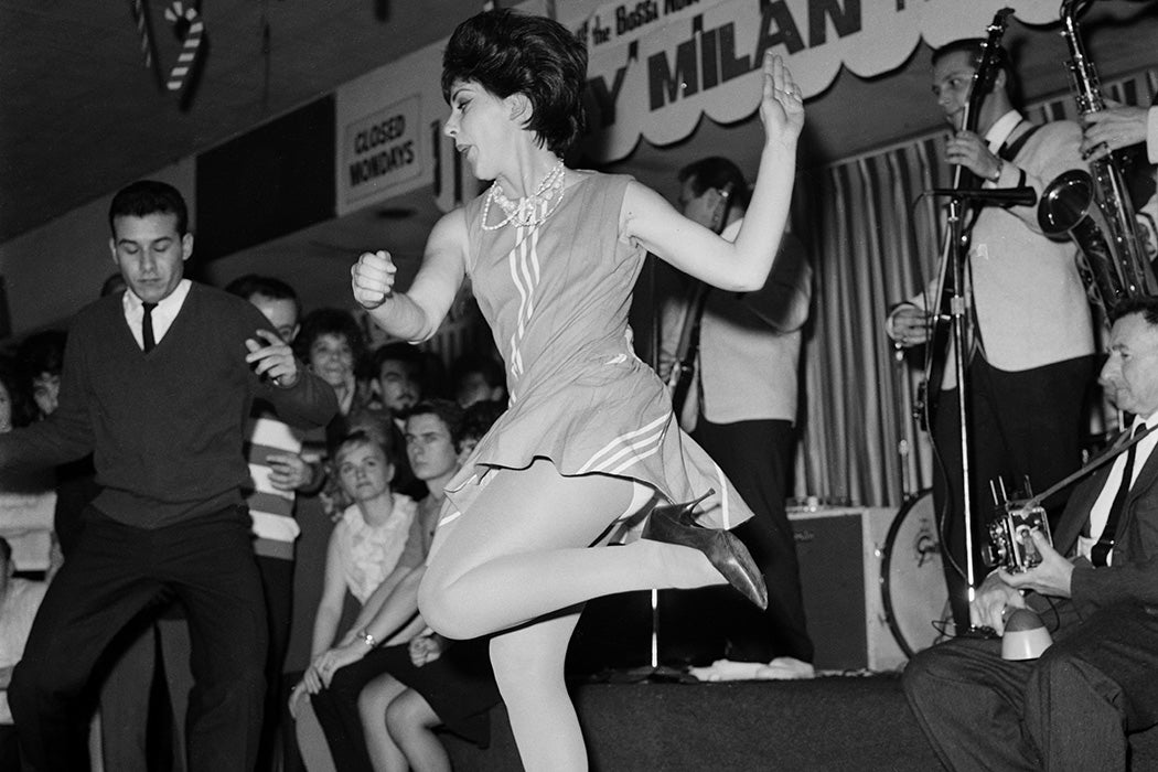 Young adults dance the Bossa Nova and the Twist during a dance contest with Ray Milan and the Quartet in Los Angeles,California, 1964