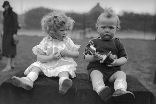 Photograph: Twins Michael and Mary Kerby fail to convey any enthusiasm upon winning a trophy in a Baby Show at Ruislip, Middlesex, May 1934