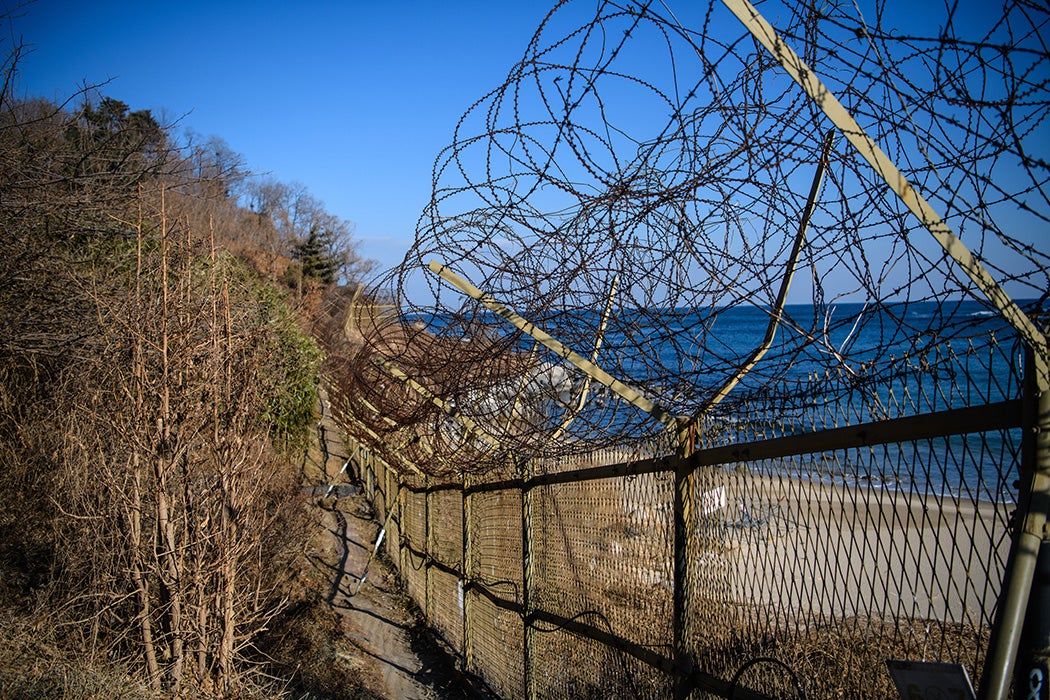 A barbed wire fence runs along a beach near the Korean Demilitarized Zone, on February 3, 2018 near Goseong-gun, South Korea.