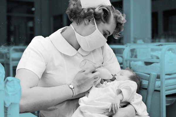 A nurse bottle-feeding a baby at St Vincent's Hospital, Montclair, Mexico, 1955