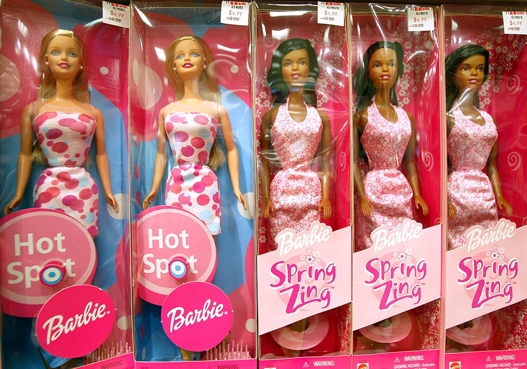 Barbie dolls sit on a shelf at the KB Toys store November 25, 2002 in Westbury, New York