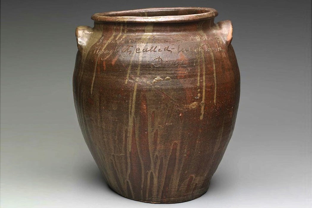 A jar by Dave the Potter, inscribed with the text, 