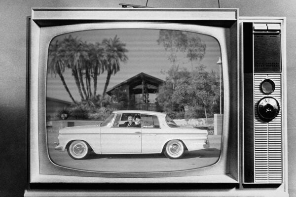 A couple in a Studebaker in Santa Barbara, CA, 1962 on a television screen