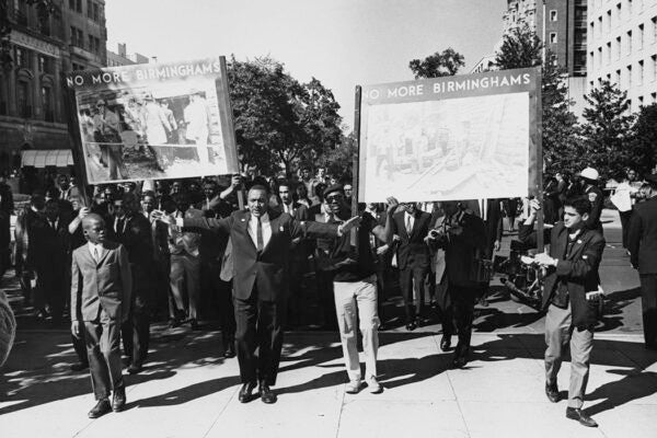 People at a civil rights demonstration holding posters reading 'No More Birminghams', in reference to the bombing of the 16th Street Baptist Church (in Birmingham, Alabama), Washington DC, US, 22nd September 1963.