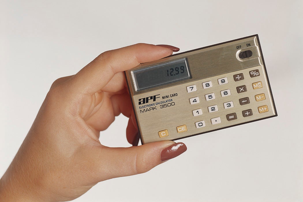Woman's hand holding small calculator