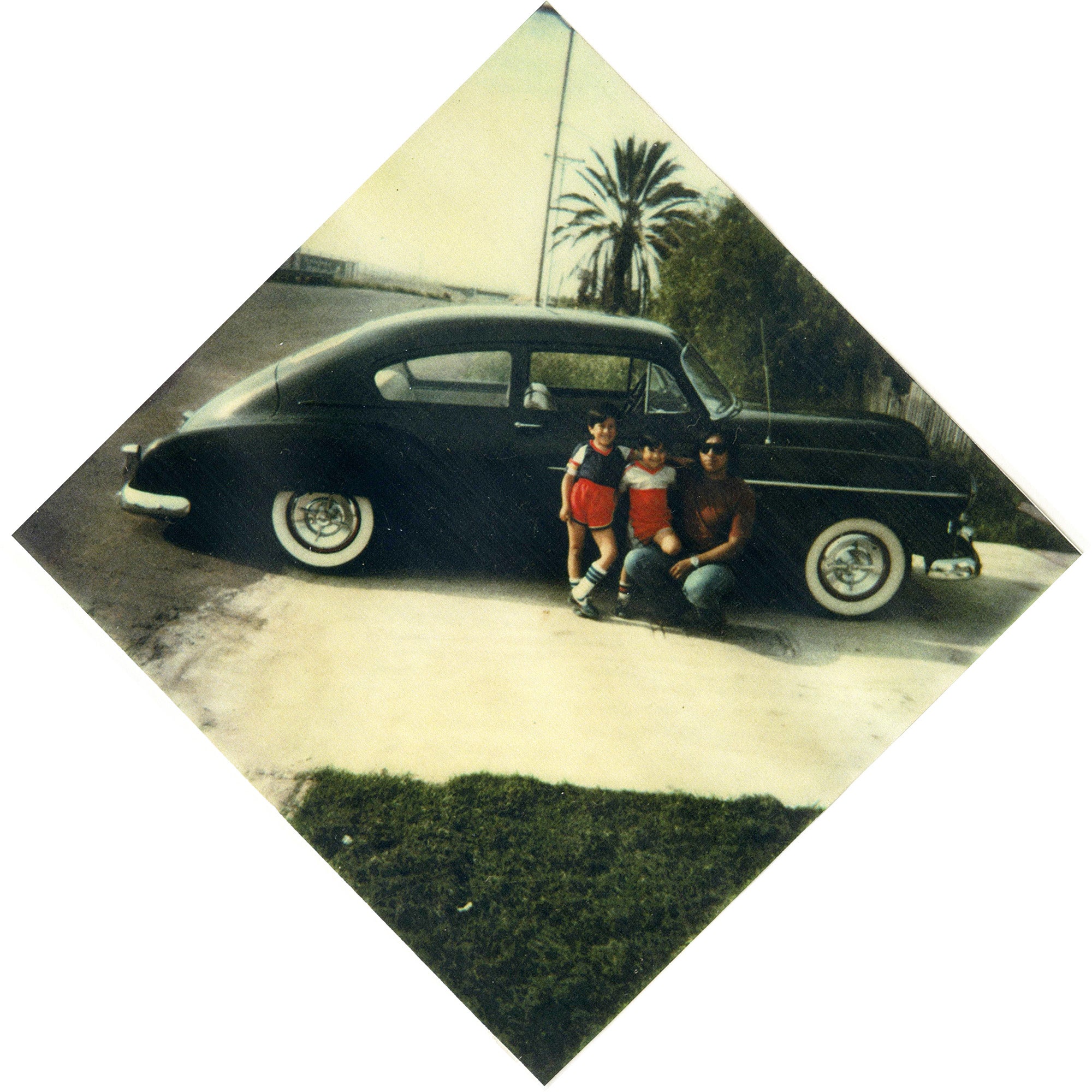 Chicano Brothers Car Club: Photograph of David Aguilar and sons with a 1965 Chevrolet Impala, 1970