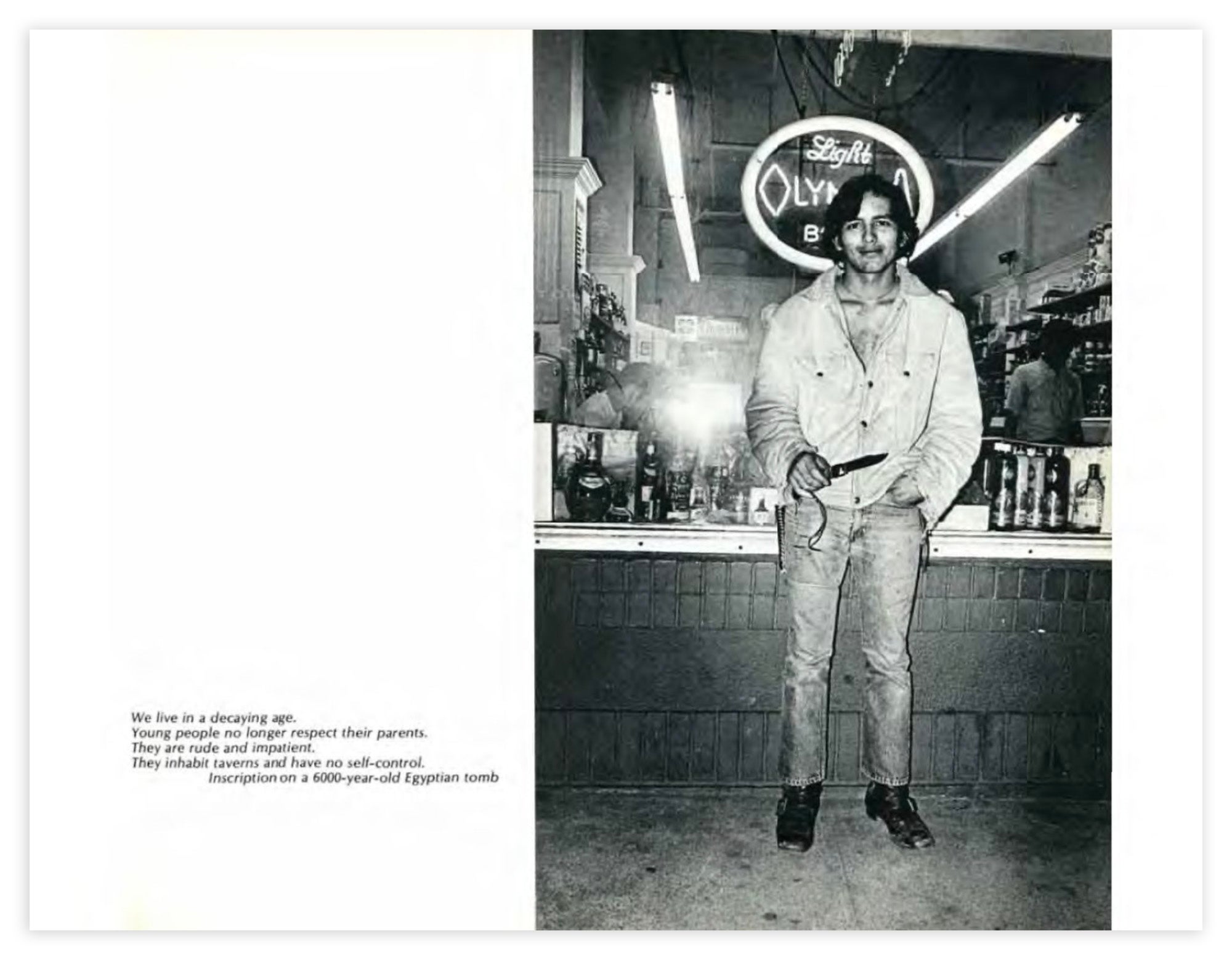 A yearbook page that includes a photograph of a man facing the camera and smiling holding a knife outside of a liquor store. 