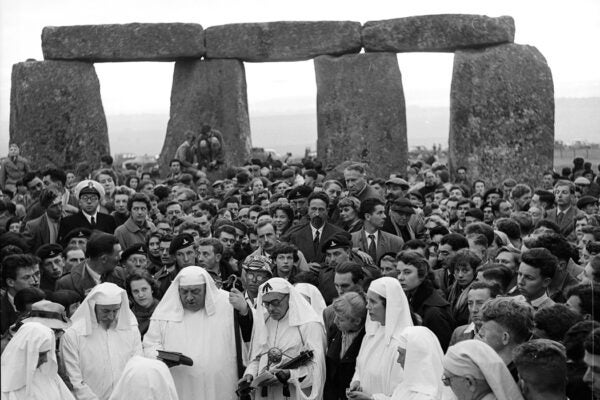 Spectators gather at Stonehenge to watch a group of Druids carry out the Dawn Ceremony on the summer solstice, or longest day of the year, 1956