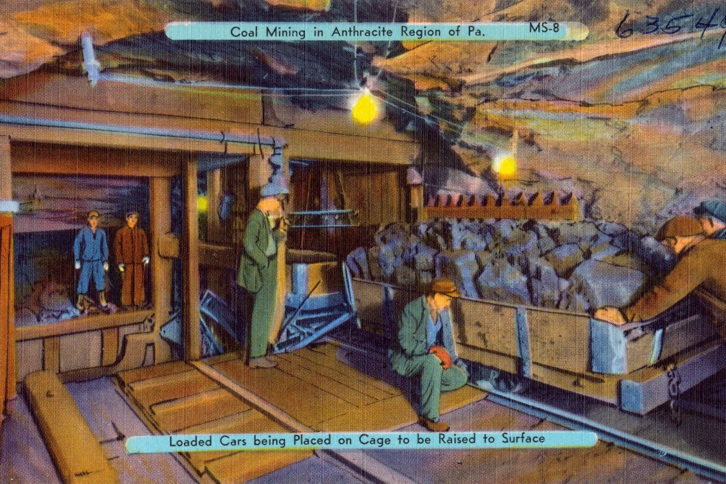 Coal mining, Anthracite Region of Pa. Loaded cars being placed on cage to be raised to surface. Post card from between circa 1930 and circa 1945.