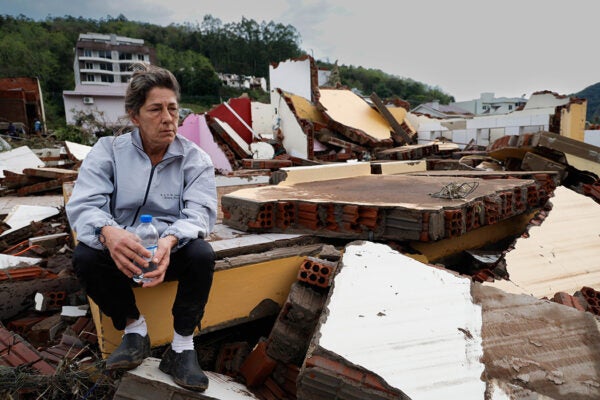 Nelsa Teresinha sits on the debris of her house which was destroyed by the flood on September 7, 2023 in Muçum, Brazil.