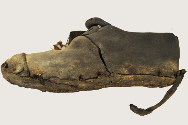 Child's shoe discovered in a wall, probably put there to protect a child from evil spirits, Lancashire, 1704