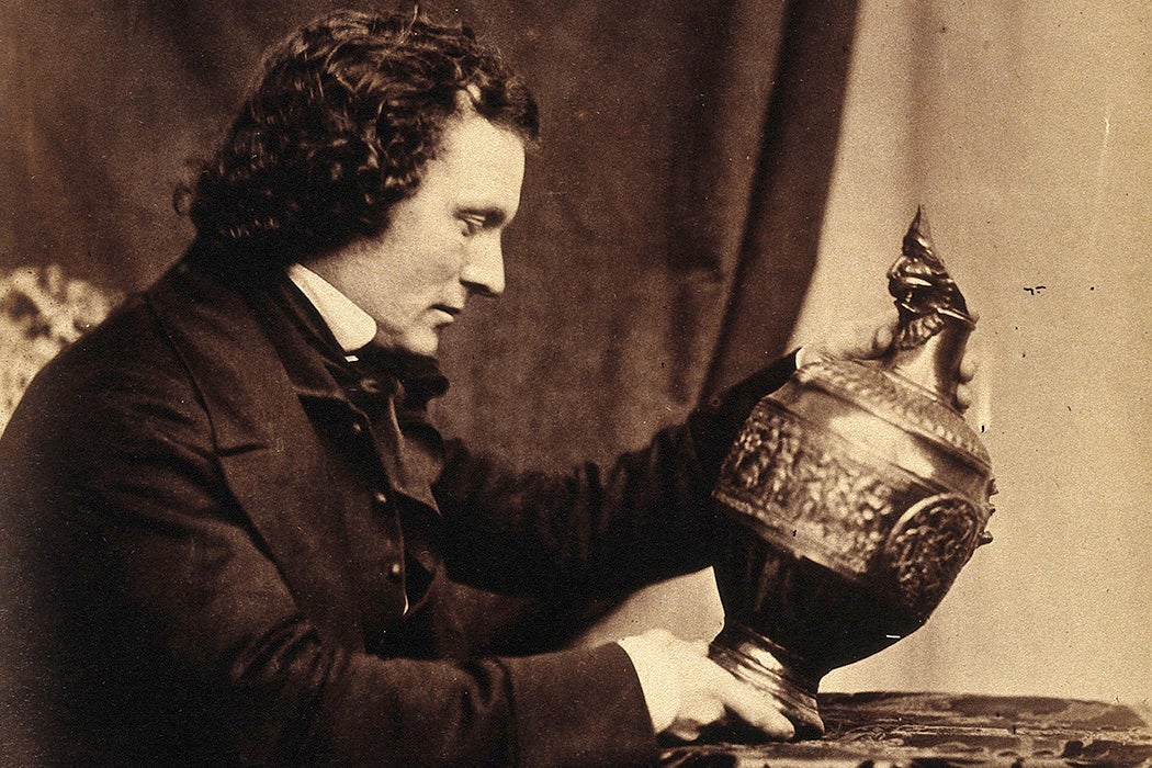 Joseph Durham looking at an urn