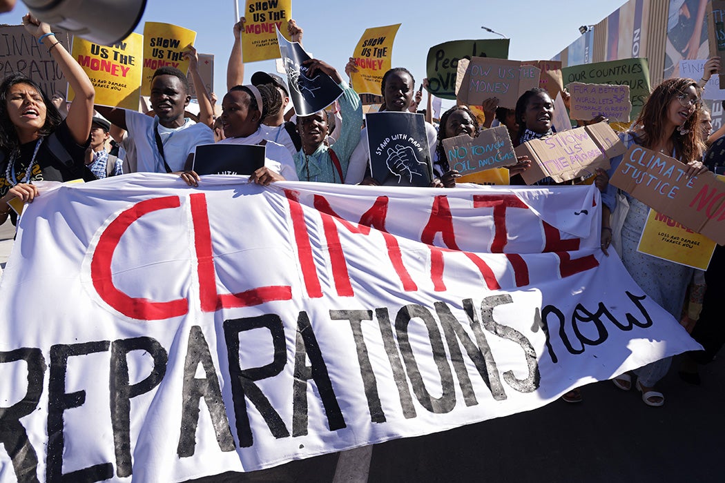 Young protesters demanding climate reparations payment from rich countries to poor countries impacted by climate loss and damage, November 11, 2022