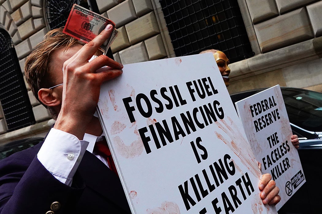 People gather at the Federal Reserve building to call on financial institutions to divest from fossil fuels on the ninth anniversary of Superstorm Sandy on October 29, 2021 in New York City.