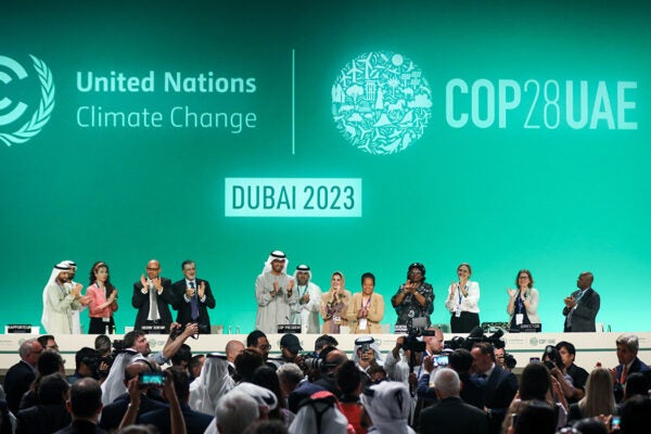 Delegates applaud after a speech by Sultan Ahmed Al Jaber (C), President of the UNFCCC COP28 Climate Conference, during a plenary session on day thirteen of the UNFCCC COP28 Climate Conference on December 13, 2023 in Dubai, United Arab Emirates.