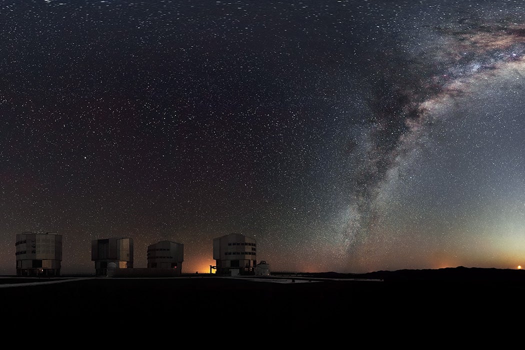 The Milky Way arches across this rare 360-degree panorama of the night sky above the Paranal platform, home of ESO’s Very Large Telescope. The image was made from 37 individual frames with a total exposure time of about 30 minutes, taken in the early morning hours. The Moon is just rising and the zodiacal light shines above it, while the Milky Way stretches across the sky opposite the observatory. The open telescope domes of the world’s most advanced ground-based astronomical observatory are all visible in the image: the four smaller 1.8-metre Auxiliary Telescopes that can be used together in the interferometric mode, and the four giant 8.2-metre Unit Telescopes. To the right in the image and below the arc of the Milky Way, two of our galactic neighbours, the Small and Large Magellanic Clouds, can be seen. Links Extended to 360 x 180 degrees (with black) version of this image