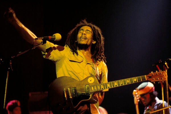 Photo of Bob MARLEY; performing live on stage,