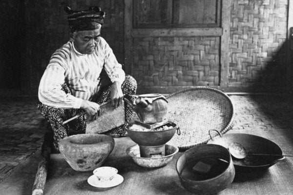 A dukun preparing medicine, c. 1910-1940