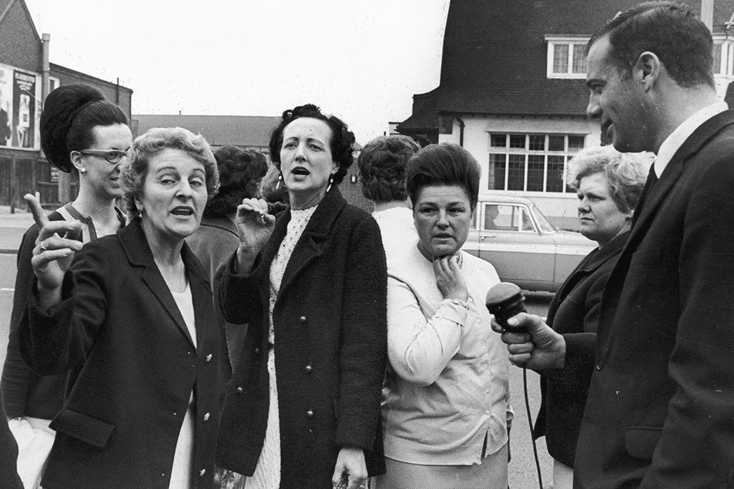 Striking women machinists from the Ford plant at Dagenham are interviewed upon their arrival at Rainham for a meeting with the National Union of Vehicle Builders, 18th June 1968.