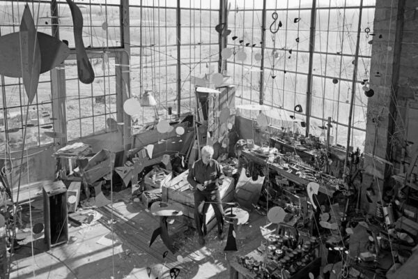 American sculptor Alexander Calder in a studio surrounded by his work, c. 1955