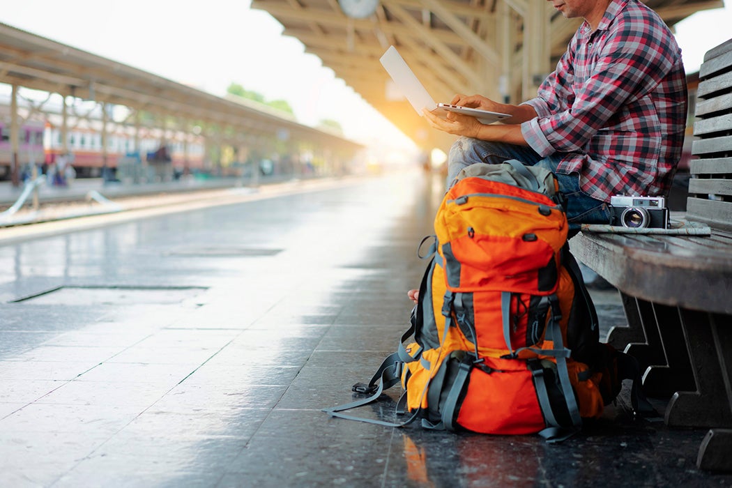 freelance working at train station before travel. work and travel concept