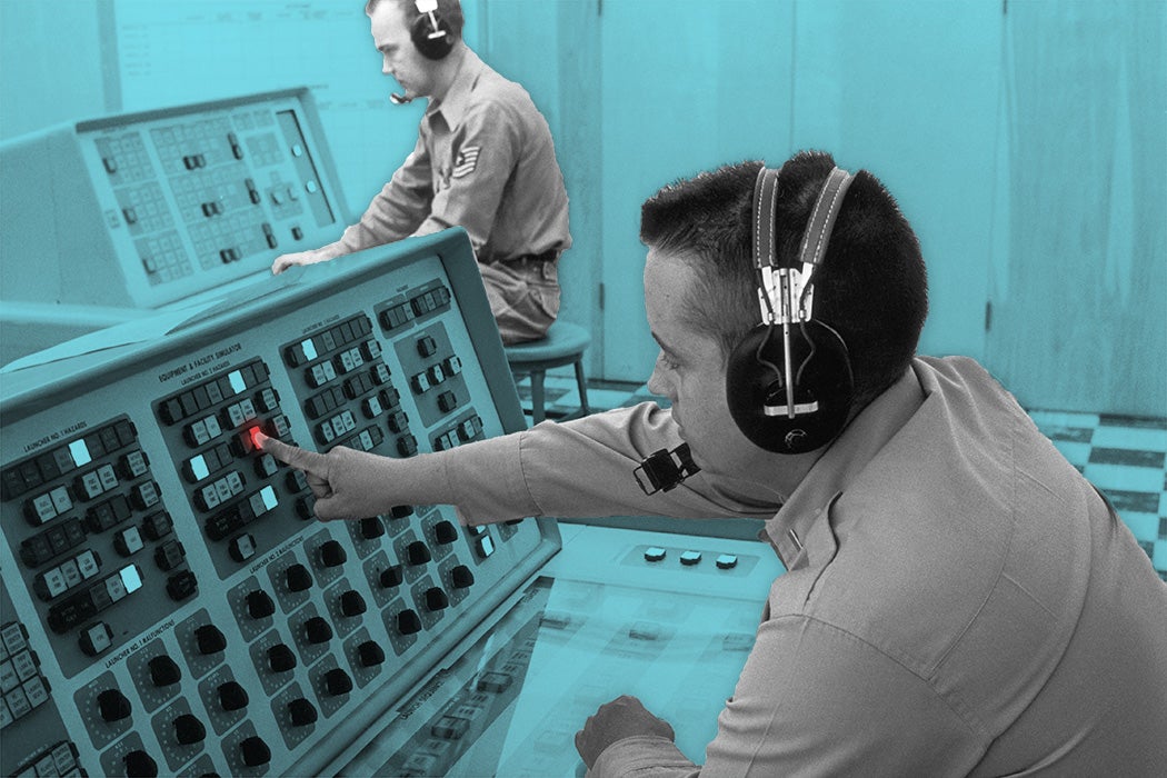 Instructor Lt. Richard C. Reynolds (right) programmes a malfunction into the launch control trainer used in the Titan missile supervisors' and planners' course at Sheppard Air Base, Texas, July 1962.