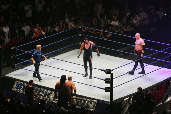 The Undertaker and ECW Champion Kane stand in the ring as the look down to Bam Neely, Chavo Guerrero, and The Great Khali during WWE Smackdown at Acer Arena on June 15, 2008 in Sydney, Australia.