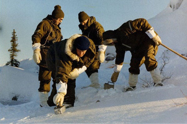 Operation Morning Light team members, dressed in specially designed arctic clothing, begin the painstaking process of searching the area with hand-held radiation detectors.