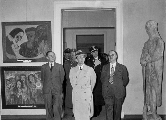A photograph of Nazi propagandist Joseph Goebbels’ visit to the exhibition titled Entartete Kunst (Degenerate Art) in Munich, 1937. At left, from top, two paintings by Emil Nolde: Christ and the Sinner (1926) and the Wise and the Foolish Virgins (1910), a painting that has disappeared.
