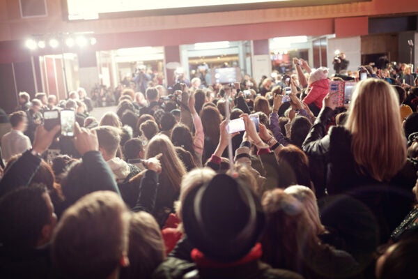 Crowd taking photographs on mobile phones