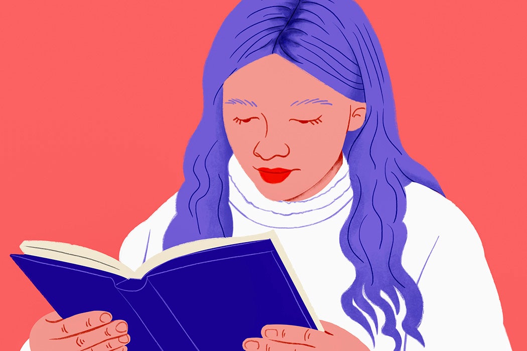 Close up girl with purple hair reading book