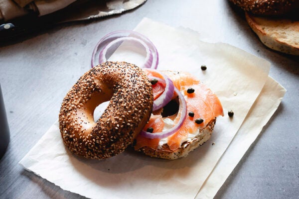 Close-up of Lox Bagel with onions on paper sheet