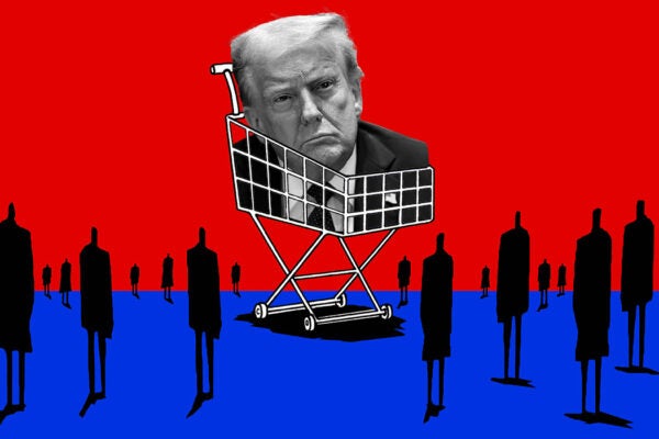 People standing around a shopping cart with Trump's head inside