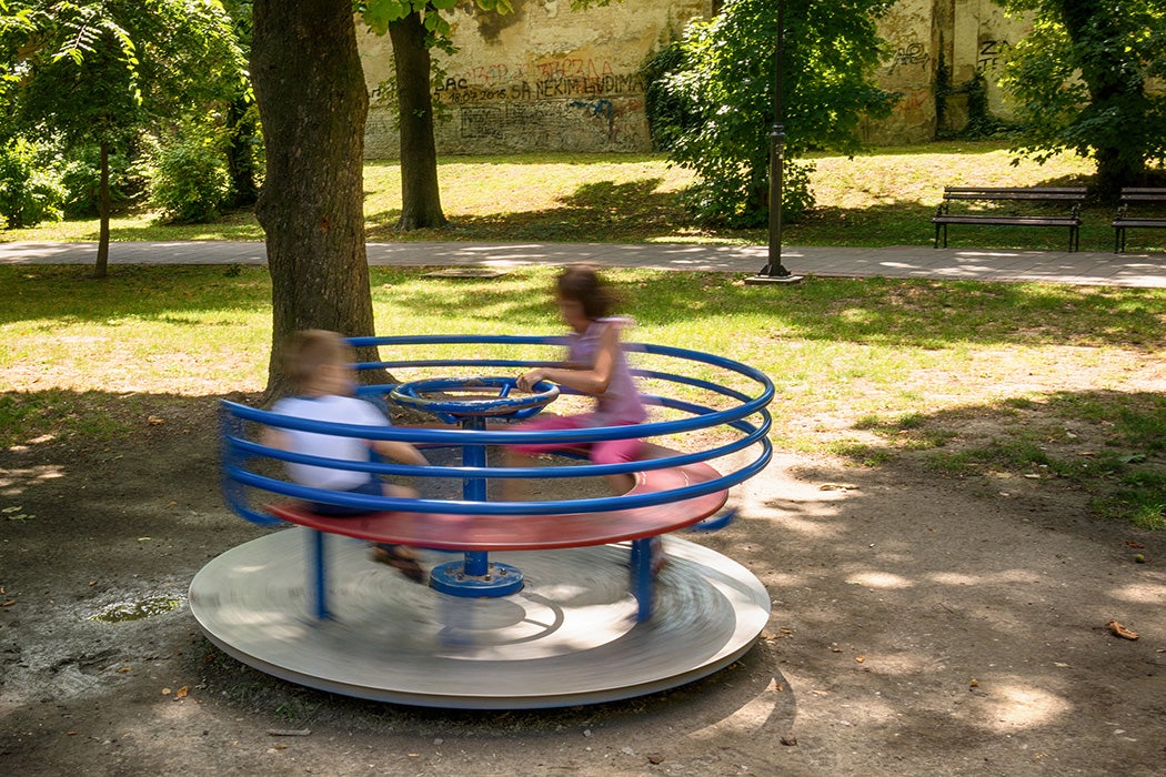 Children playing on a roundabout at a playground