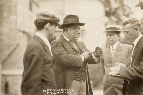Theodore Roosevelt speaking with reporters