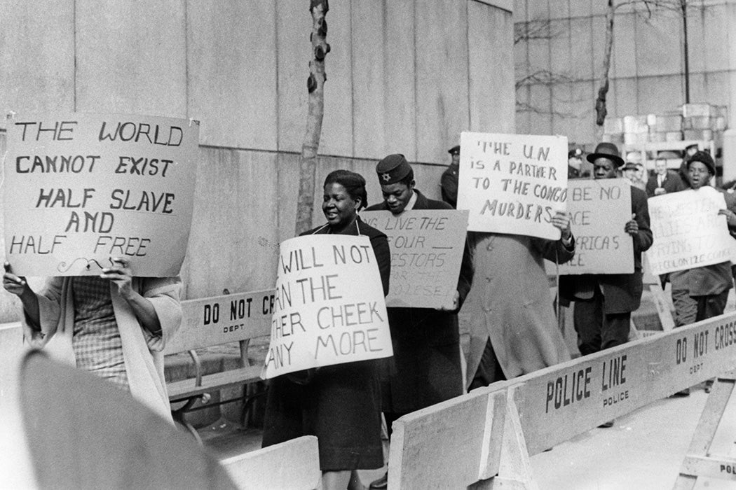 Protestors picket behind a security barrier outside the 15th United Nations General Assembly at the United Nations complex in New York City, 1961.