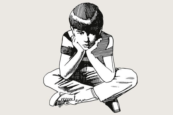 A sad child sitting on the floor