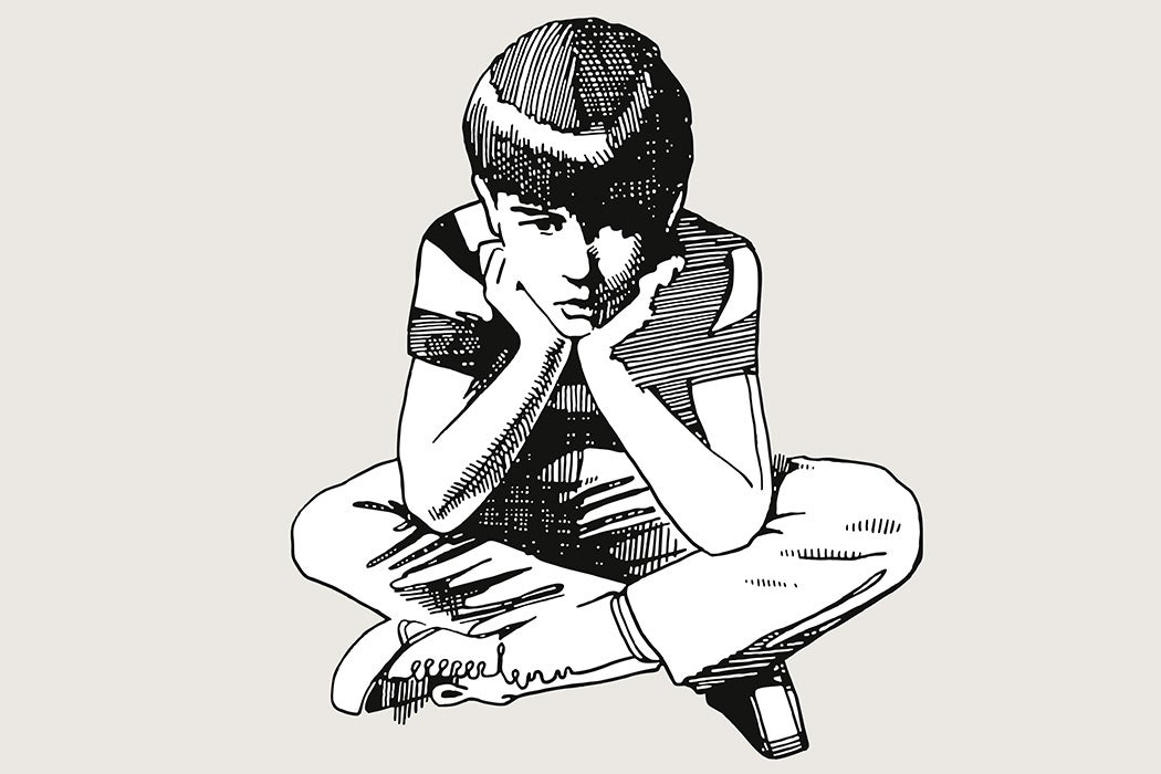 A sad child sitting on the floor