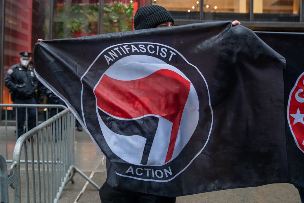 People hold Antifa flags at Trump Tower to counter protest the "White Lives Matter" march and rally on April 11, 2021 in New York City.