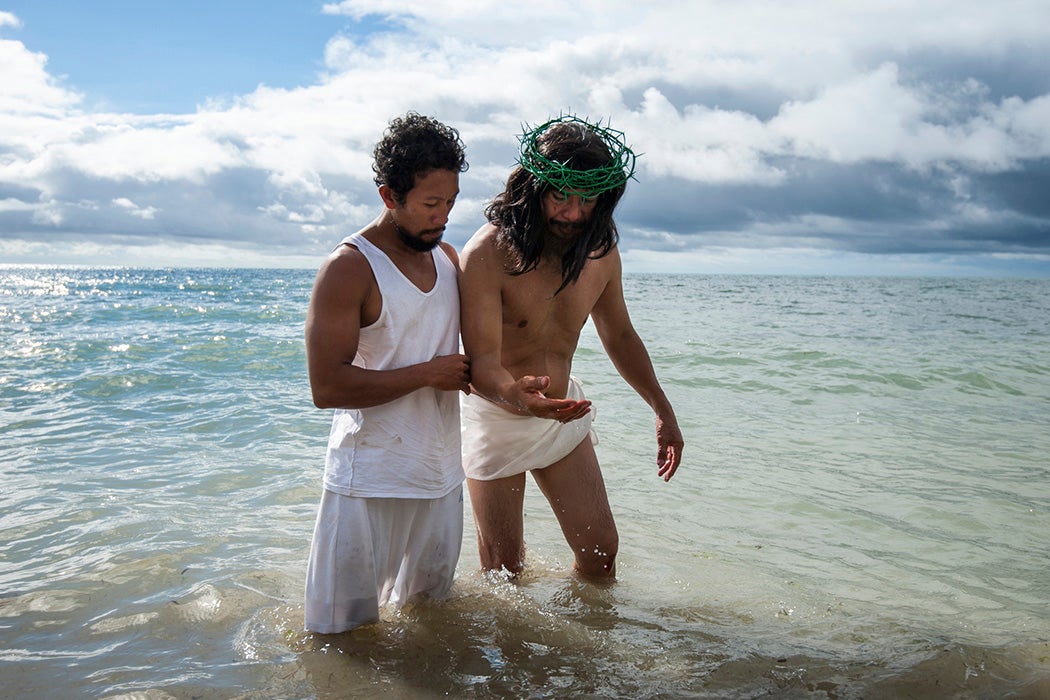 Gilbert Bargayo washes his crucifixion wounds after being crucified on Good Friday in Tuburan, Cebu, Philippines.