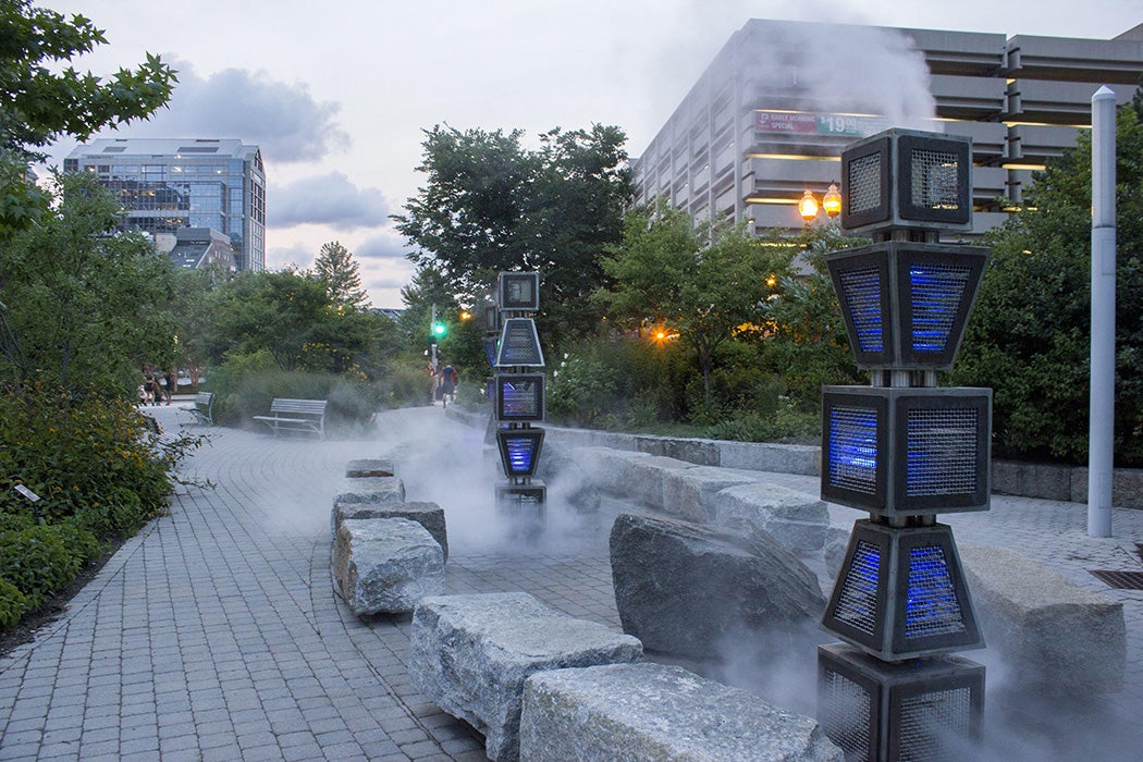 Wharf District Parks. An interactive sculpture (Harbor Fog designed by Ross Miller Studio, Inc.) which is surrounded by stone benches.
