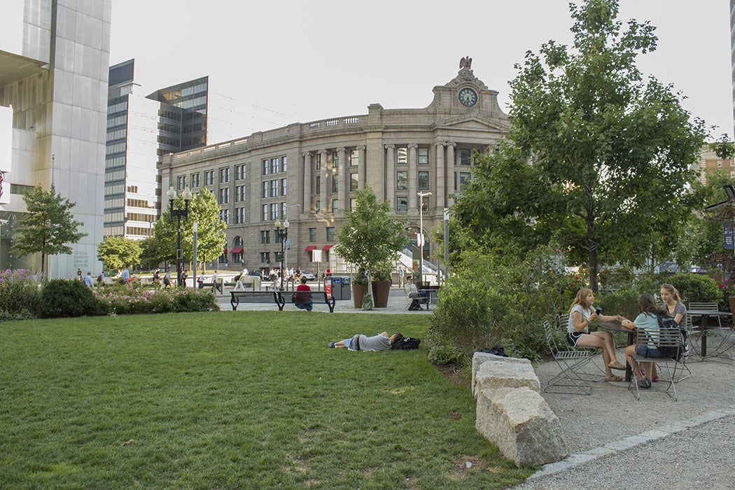 Dewey Square Park View near Summer Street which intersects Atlantic Avenue and Purchase Street. There is a small enclave which has cafe chairs and tables as well as a lawn area.