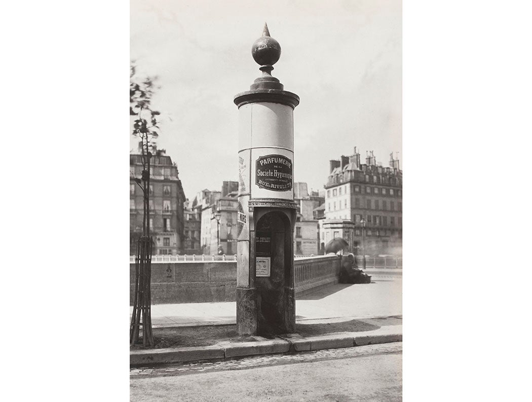 Single stall masonry urinal mounted with globe and advertising on sides