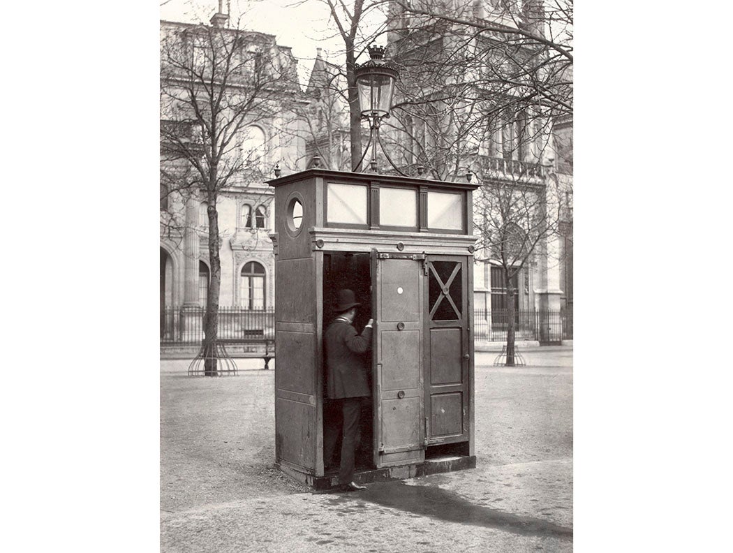 Slate cubicle with two stalls and doors, on curb of footpath