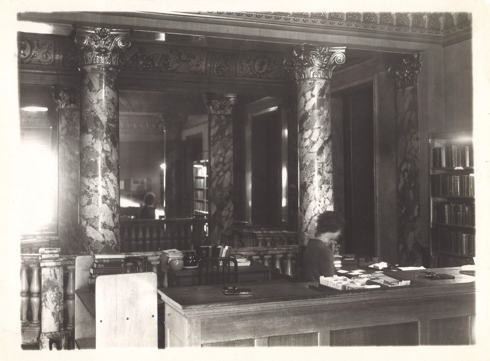 Circulation desk with mirrored wall behind.