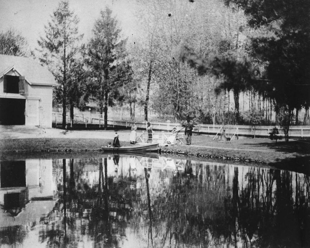 Group by a pond with boat and barn, Hempstead, New York