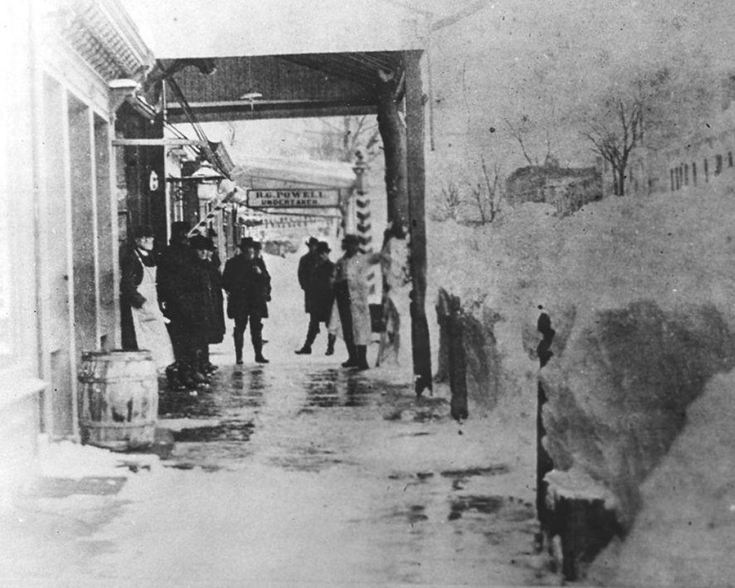 Men standing on shoveled Main Street sidewalk in Hempstead after the blizzard of March 1888