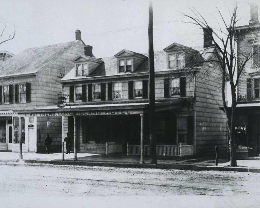 Street view of Island Hotel and adjacent buildings, Hempstead