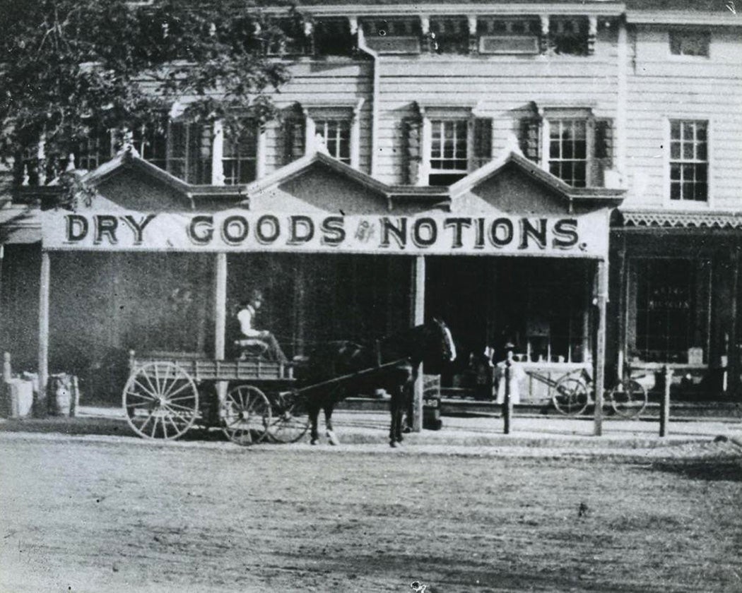 Dry goods and notions store with horse-drawn wagon, Hempstead