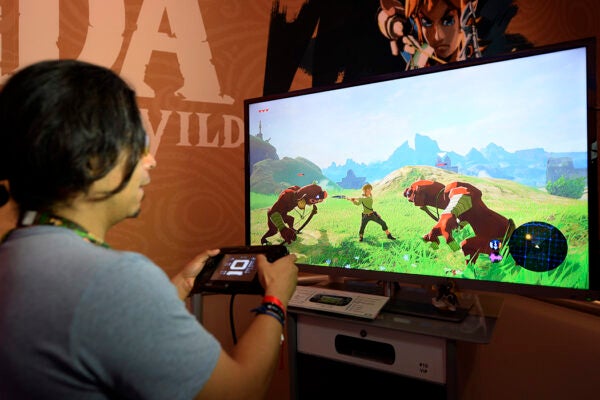Gamers try out the new video game "The Legend of Zelda: Breath of the Wild" during the annual E3 2016 gaming conference.